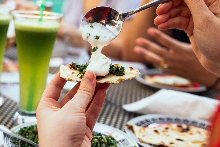 Discover the rich flavors of Dubai as you savor local delicacies from creamy dips to refreshing drinks all while enjoying the company of fellow food enthusiasts and local guides.